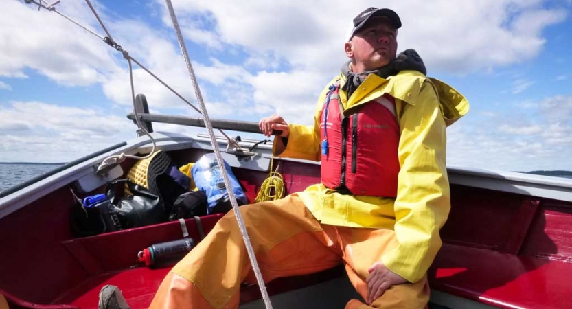 a veteran navigates a sailboat on an outward bound expedition